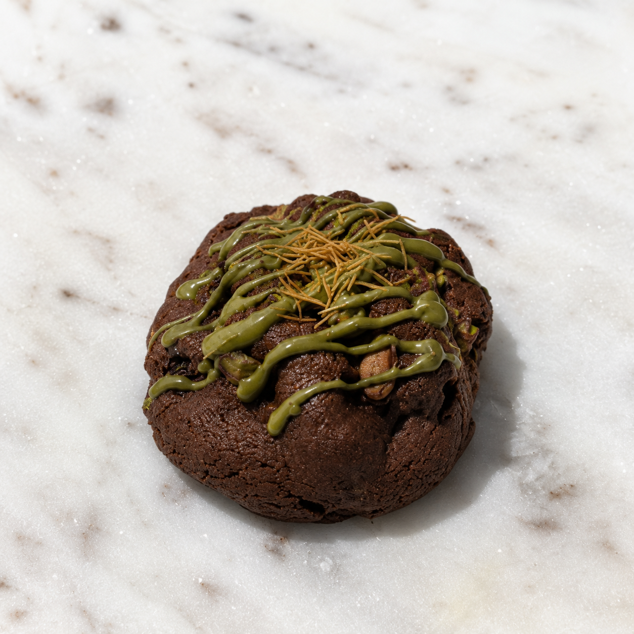 ChocoDubai Crunch, a dark chocolate cookie with pistachio drizzle and crunchy topping